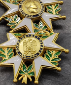 Close-up of a gold and white military decoration with emblems on a dark background