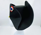 Black bicorn hat with decorative emblem on a white background