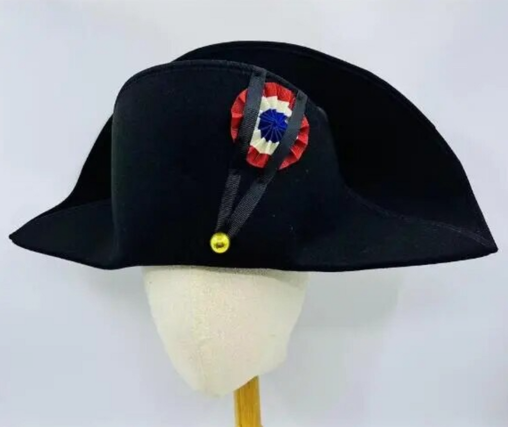 Black bicorn hat with decorative emblem on a mannequin head against a white background