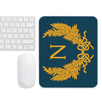 white apple mouse and apple keyboard next to a Napoleon Mouse pad to play Empire: Total War from Creative Assembly