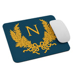 white apple mouse next to a Mouse pad to play Empire: Total War from game developer Creative Assembly