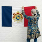Person in historical attire hanging a flag with a coat of arms on a white brick wall.